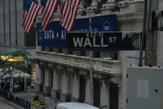 a street sign on wall street in new york city by Robb Miller courtesy of Unsplash.