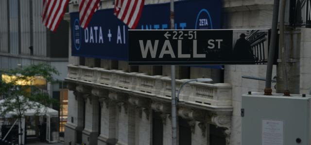 a street sign on wall street in new york city by Robb Miller courtesy of Unsplash.